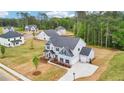 Aerial view of a light gray two-story home with an attached garage, long driveway, and spacious yard at 1452 Stephens View Dr, Loganville, GA 30052