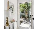 Bright foyer with view to backyard, marble table, artwork, and hardwood floors at 321 Dilbeck Ne Cir, Atlanta, GA 30342