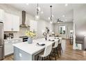 Open-concept kitchen with island, stainless steel appliances, and views to living room at 321 Dilbeck Ne Cir, Atlanta, GA 30342