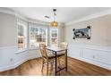 Cozy breakfast nook with a bay window, wood floors, and a charming pendant light fixture at 6604 Destiny Se Dr, Mableton, GA 30126