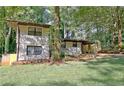 Charming two-story home featuring a covered carport, lush trees, and a freshly mowed front yard at 1453 Midview Dr, Decatur, GA 30032