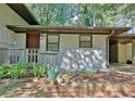 Charming front porch with brick and siding exterior, featuring a wood railing and a beautiful wooden front door at 1453 Midview Dr, Decatur, GA 30032