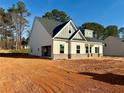 New construction featuring a mix of siding and brick accents, plus an attached garage at 1471 Stephens View Dr, Loganville, GA 30052