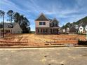 New home under construction with a brick foundation, white siding, and a modern design at 3603 Squires Park Ln, Loganville, GA 30052