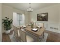 Formal dining room with hardwood floors, decorative trim, and a window providing natural light at 776 Myerston Ct, Lawrenceville, GA 30044