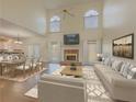 Spacious living room featuring a fireplace, vaulted ceiling, and an open-concept layout with dining area at 776 Myerston Ct, Lawrenceville, GA 30044