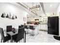 Modern kitchen featuring white cabinets, a center island, and stylish lighting at 2081 Beecher Sw Rd, Atlanta, GA 30311