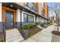 Townhome exterior showcasing well-manicured landscaping, updated brickwork, and a contemporary entry door at 1307 Glenwood Se Ave, Atlanta, GA 30316