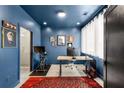 Home office boasting deep blue walls, stylish decor, and an adjacent bathroom with glass shower at 1307 Glenwood Se Ave, Atlanta, GA 30316
