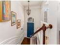 Bright entryway with hardwood floors, chandelier, stylish artwork, and a blue front door at 24 Rockland Pl, Decatur, GA 30030