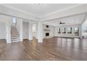 Open-concept living room with fireplace, abundant natural light, and hardwood floors at 325 William Falls Dr, Canton, GA 30114
