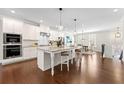 Modern white kitchen with stainless steel appliances, granite countertops, and a spacious island at 3538 Davenport Rd, Duluth, GA 30096
