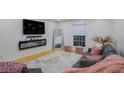 Beautiful living room with a modern fireplace, hardwood floors, and comfortable seating near a large window at 5600 Kingsport Dr, Atlanta, GA 30342