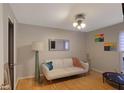 Cozy living room with hardwood floors, a comfortable white sofa, and artistic wall decor at 5600 Kingsport Dr, Atlanta, GA 30342