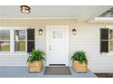 Charming front door with decorative lanterns flanked by potted plants adding curb appeal and style at 3784 Robinson Ne Rd, Marietta, GA 30068