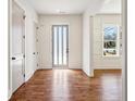 Home foyer boasts hardwood floors, white walls, and detailed trim work at 482 Majestic Oaks Pl, Smyrna, GA 30082