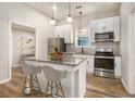 Stylish kitchen featuring white cabinets, stainless steel appliances, and a granite-topped island at 1705 Evans, Atlanta, GA 30310