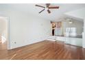 Open-concept living room featuring hardwood floors, modern lighting, staircase, and neutral paint at 4254 River Green Nw Dr # 611, Atlanta, GA 30327