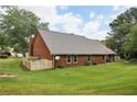 Well maintained brick home featuring a green backyard with a fence and patio at 555 Brickleberry Ln, Roswell, GA 30075