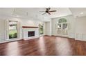 Bright living room with hardwood floors, a fireplace and large windows at 555 Brickleberry Ln, Roswell, GA 30075