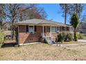 Classic brick home with a tidy front yard, featuring a small porch with steps at 1210 Stoneybrook Rd, Forest Park, GA 30297