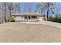 Inviting single-story home with a classic design, a covered front porch, and a well-manicured lawn at 2222 Ivy Crest Dr, Buford, GA 30519