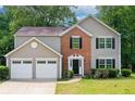 Charming two-story home with a well-manicured lawn and an attached two-car garage at 4110 Ridgebrook Bnd, Cumming, GA 30028