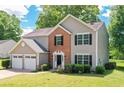 Charming two-story home with a well-manicured lawn and an attached two-car garage at 4110 Ridgebrook Bnd, Cumming, GA 30028