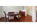 Dining room with hardwood floors, detailed trim, and a dark wood dining table at 981 Sonoma Dr, Lawrenceville, GA 30045