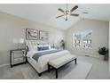 Bright bedroom with vaulted ceilings, ceiling fan, neutral walls, and a large window providing natural light at 2939 Greyhawk Ln, Cumming, GA 30040