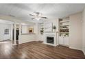 Bright living room with a fireplace, built-in shelving, hardwood floors, and an open layout at 2939 Greyhawk Ln, Cumming, GA 30040