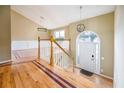 Inviting foyer featuring hardwood floors, a staircase with white railings, and modern lighting fixtures at 4170 Hopkins Bluff Way, Duluth, GA 30096