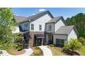 Stunning two-story home with stone accents and a welcoming entrance, surrounded by landscaped gardens at 4987 Kyle Dr, Powder Springs, GA 30127