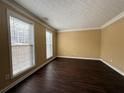 Bright living room with large windows, dark floors and neutral walls at 675 Paper Creek Dr, Lawrenceville, GA 30046