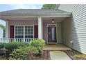 Inviting front porch features white columns, red shutters, and manicured landscaping at 1109 Willow Crest Way, Austell, GA 30168