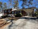 Brick home featuring covered parking, a well-maintained yard, and a classic architectural design at 2977 Appling Dr, Atlanta, GA 30341