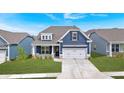 Inviting exterior view of a blue home showcasing its well-manicured lawn and complementary landscaping at 53 Colonial Ter, Villa Rica, GA 30180