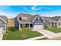 A view of a blue home's exterior showcasing the clean lines, manicured lawn, and welcoming curb appeal at 53 Colonial Ter, Villa Rica, GA 30180