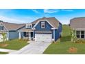 Attractive blue home exterior with a well-kept lawn, a two-car garage and a clean driveway at 53 Colonial Ter, Villa Rica, GA 30180