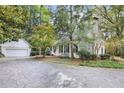 Exterior view of the home with a detached garage, mature trees, and a circular driveway at 643 Longstreet Dr, Marietta, GA 30064