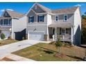 Modern two-story home featuring a front porch, attached garage, and manicured front lawn at 218 Highgrove Way, Dallas, GA 30157