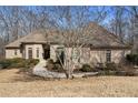 Charming brick home featuring a well-manicured lawn and an inviting entrance walkway at 490 Revenna Trl, Fayetteville, GA 30214