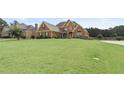 Beautiful home with a large front yard, mature trees, and well-maintained landscaping at 50 Cannonade Ct, Covington, GA 30016