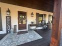 Charming front porch with welcome sign, rocking chair, and rustic decor at 77 Russell Rd, Lawrenceville, GA 30043