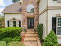 Stone pathway leads to a double front door with decorative glass and manicured landscaping at 1402 Downington Nw Vw, Acworth, GA 30101