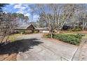 Spacious home with a long driveway surrounded by mature trees and lush landscaping at 3093 Brookshire Way, Duluth, GA 30096