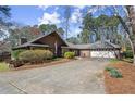 Beautiful home with a well-maintained lawn, mature trees, and an attached two-car garage at 3093 Brookshire Way, Duluth, GA 30096