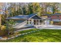 Single-story home boasts a modern brick exterior, an attached garage, and a beautifully landscaped front yard at 842 Laurelmont Sw Dr, Atlanta, GA 30311