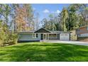 This single-Gathering home features a well-manicured lawn, an attached garage, and a modern brick exterior at 842 Laurelmont Sw Dr, Atlanta, GA 30311