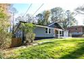 Charming single-story home featuring a well-manicured lawn and a blend of modern and traditional architectural elements at 842 Laurelmont Sw Dr, Atlanta, GA 30311